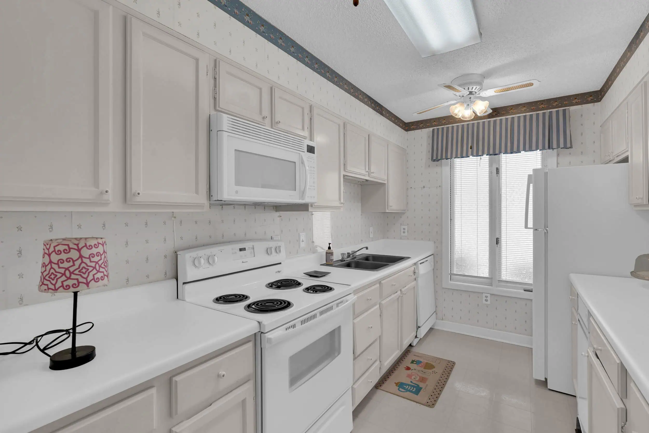 Professionally edited compact white kitchen photograph