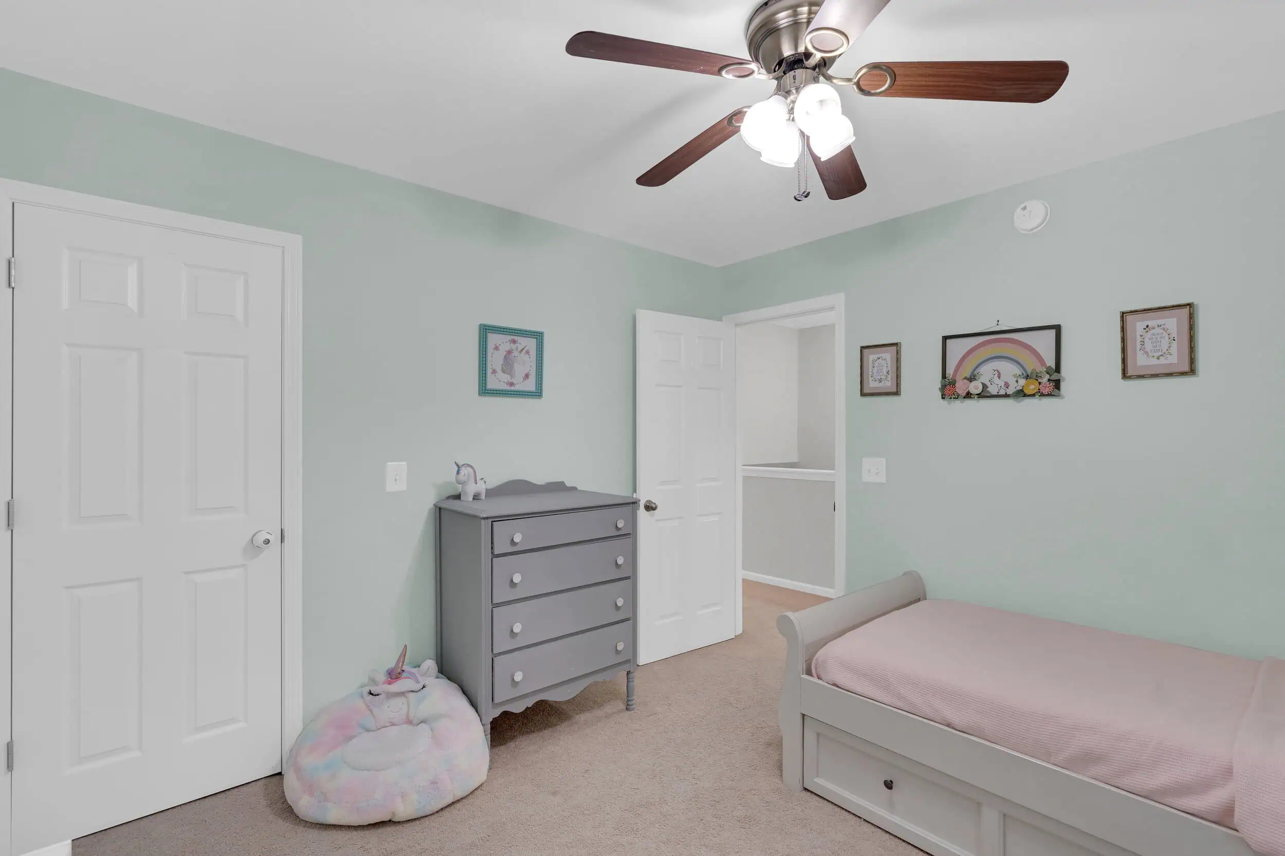 Professionally edited pastel bedroom real estate photograph