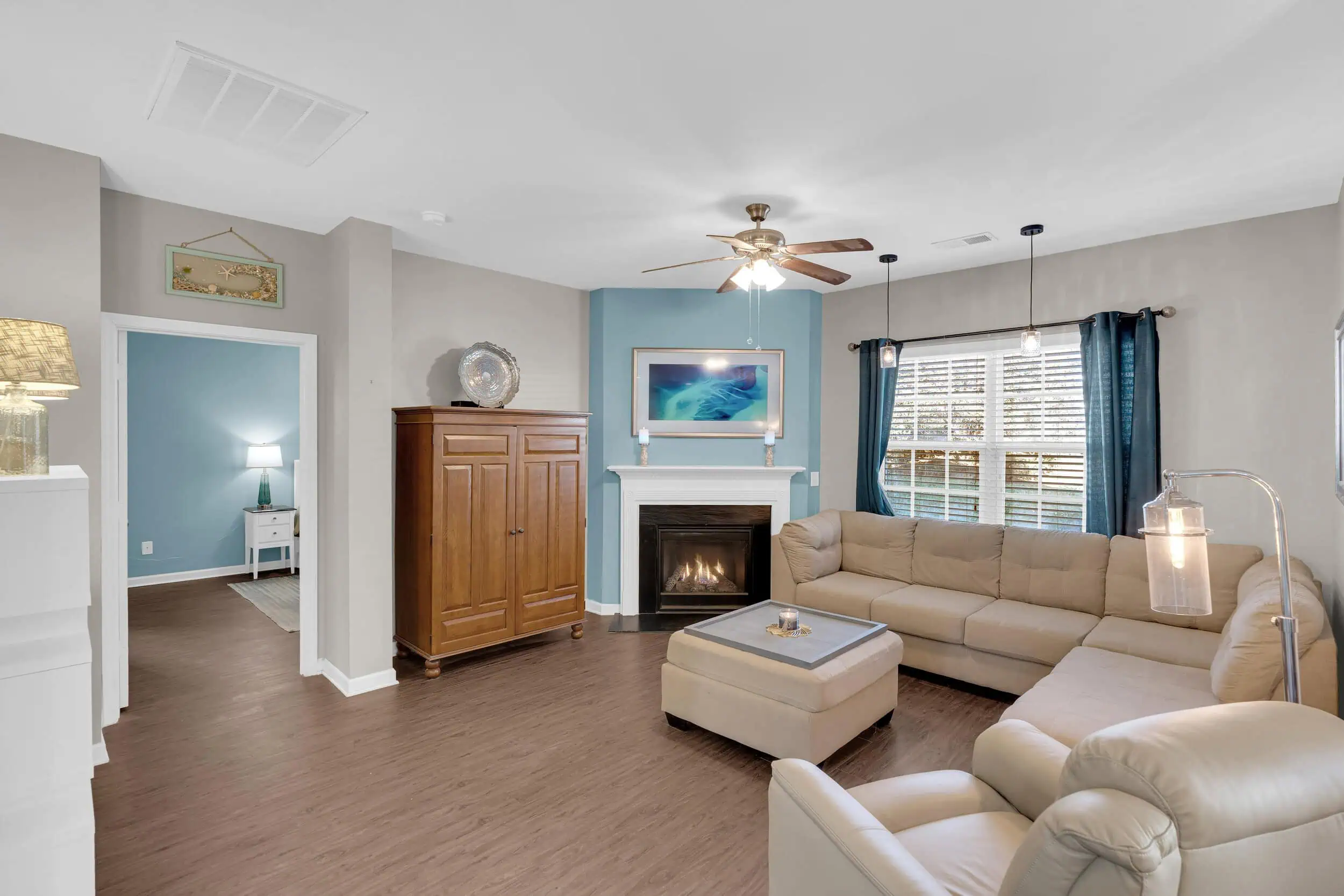 Professionally edited living room with blue accents