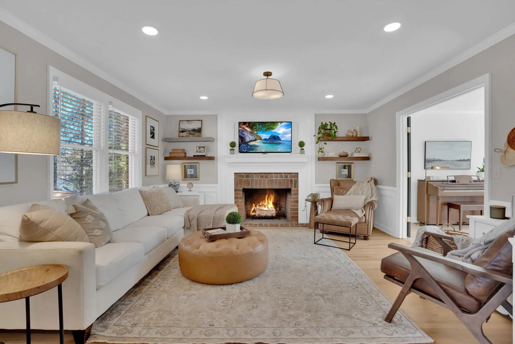 Professionally enhanced living room with fireplace and natural window light