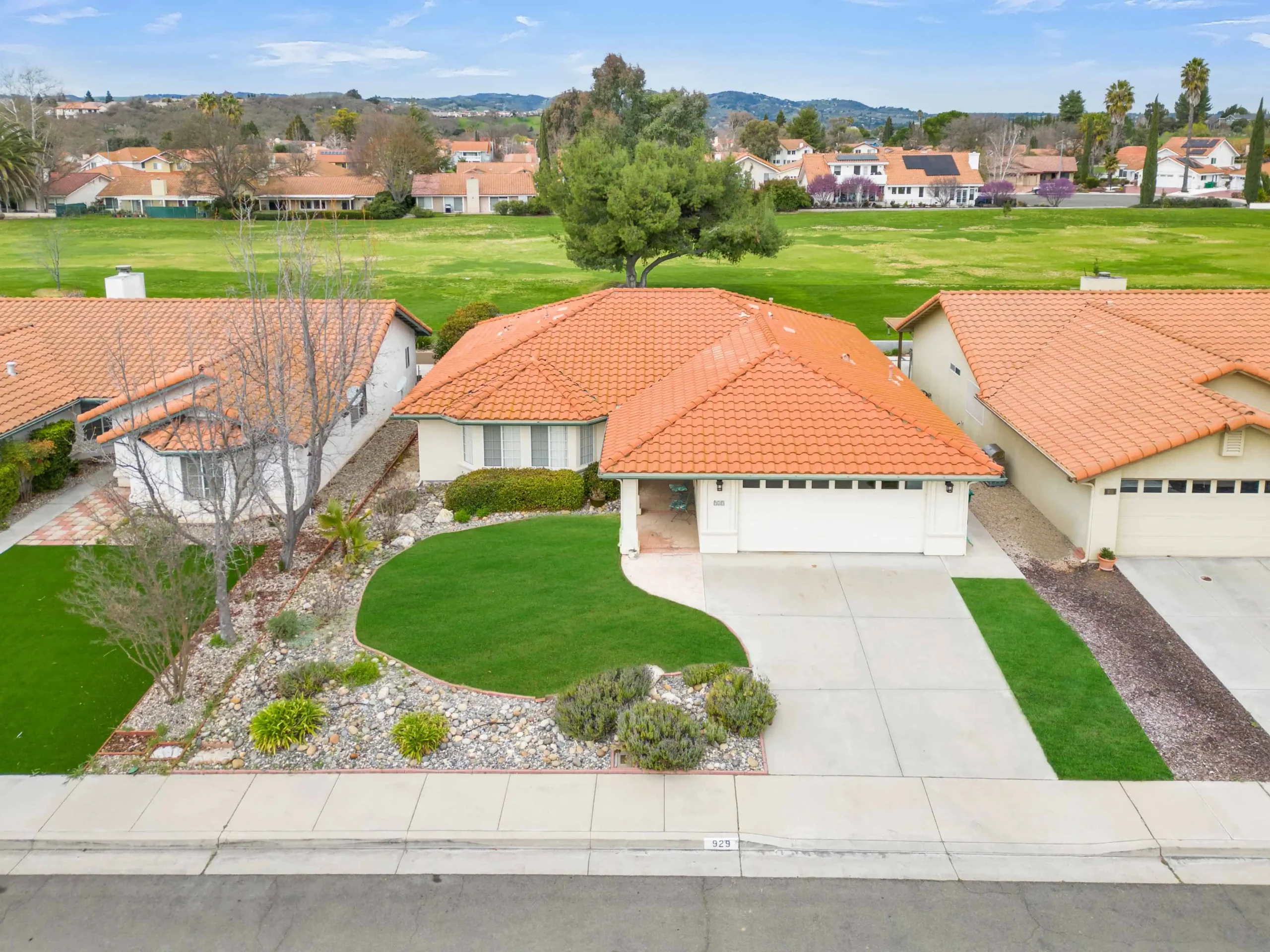 Real estate exterior with professionally enhanced green lawn